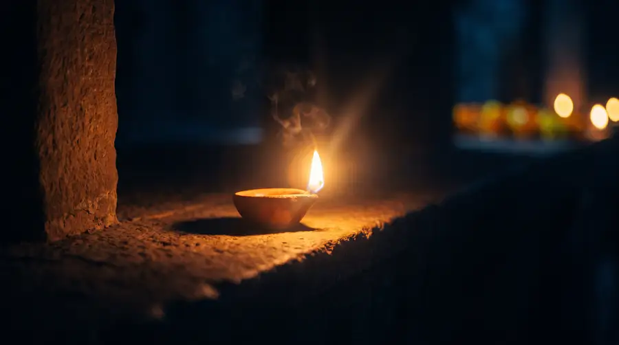 A clay lamp burning in the dark